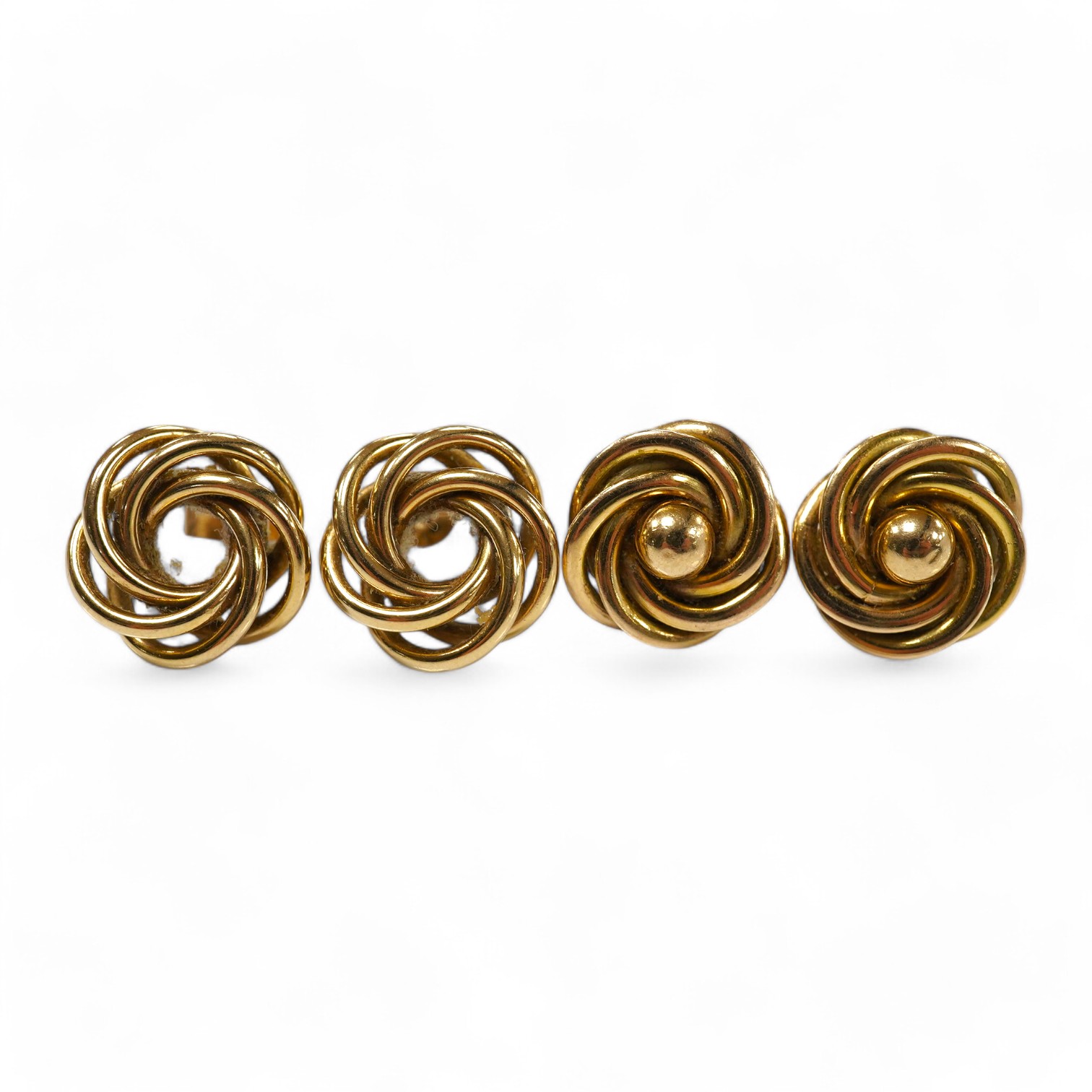 Two pairs of 9ct gold stud earrings, each of knot design, each pair 1.5cm diameter, post fittings, British hallmarks, combined gross weight 9 grams